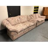 A three seater and two seater settee upholstered in geometric and floral fabric