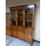 A mahogany Regency style triple door bookcase with lion mask handles, height 199.