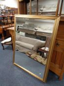 A large gilt framed bevelled overmantel mirror CONDITION REPORT: 101cm by 131cm.