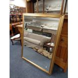 A large gilt framed bevelled overmantel mirror CONDITION REPORT: 101cm by 131cm.