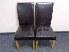 A pair of brown leather high backed dining chairs