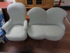 A turquoise buttoned two seater settee and matching armchair