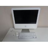 An Apple IMac with keyboard and mouse