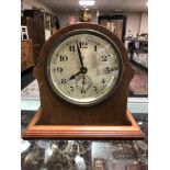 An Edwardian mahogany and pine mantel clock with silvered dial and key