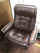 A tan leather swivel armchair