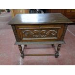 An early twentieth century carved oak storage table