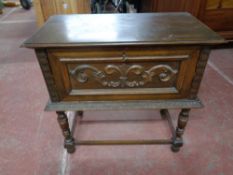 An early twentieth century carved oak storage table