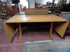 A light oak contemporary drop end dining table