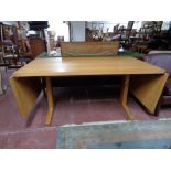 A light oak contemporary drop end dining table