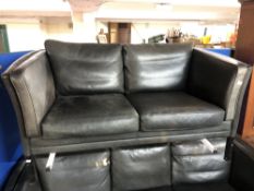 A Danish black leather two seater settee