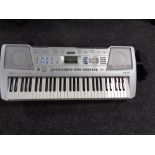 A Yamaha PSR-290 electric keyboard with case and stand