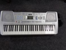 A Yamaha PSR-290 electric keyboard with case and stand