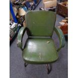 A mid century tubular metal framed dining chair upholstered in green vinyl