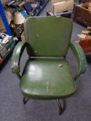 A mid century tubular metal framed dining chair upholstered in green vinyl