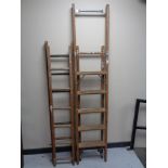 A folding wooden step ladder together with twin section extension ladder