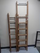 A folding wooden step ladder together with twin section extension ladder