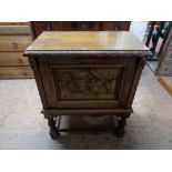 A mid century carved oak storage cabinet