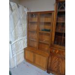 A mid century teak double door bookcase
