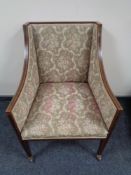 A Victorian inlaid mahogany armchair upholstered in floral fabric