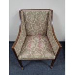 A Victorian inlaid mahogany armchair upholstered in floral fabric