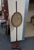 A Victorian tapestry pole screen on stand