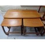 A nest of three Nathan teak tables