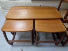 A nest of three Nathan teak tables