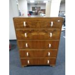 A 1930's walnut five drawer chest