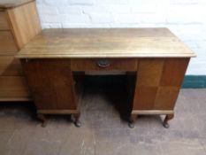 An early twentieth century oak pedestal desk