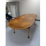 An oval walnut dining table on claw & ball feet CONDITION REPORT: 244cm long by
