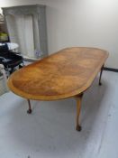 An oval walnut dining table on claw & ball feet CONDITION REPORT: 244cm long by