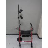 A mobility walking aid together with a metal floor lamp