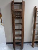 A wooden triple section extension ladder