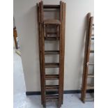 A wooden triple section extension ladder