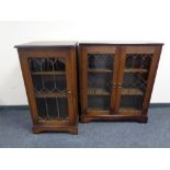 A double door bookcase with leaded glass door together with a matching hifi cabinet in oak finish