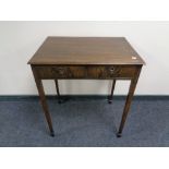 An Edwardian side table fitted with two drawers