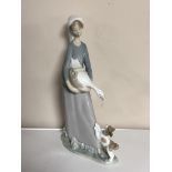 A Lladro figure, lady holding a goose.