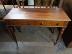 A nineteenth century two drawer writing table