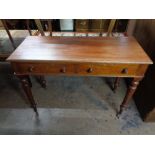 A nineteenth century two drawer writing table