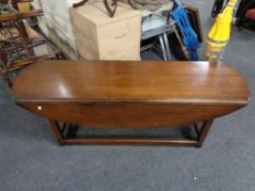 A narrow drop leaf coffee table