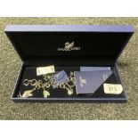 A Swarovski crystal charm bracelet, with retail tags and box.