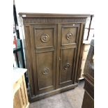 A mid century oak double door cabinet