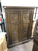 A mid century oak double door cabinet