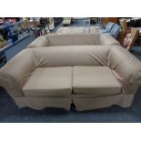 A pair of contemporary settees with loose covers