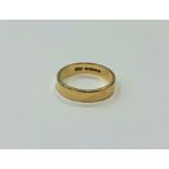 An 18ct gold band ring, size L CONDITION REPORT: 3.