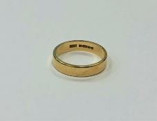 An 18ct gold band ring, size L CONDITION REPORT: 3.