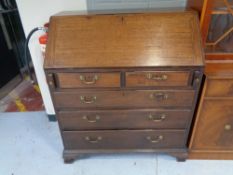 A George III mahogany bureau with brass handles