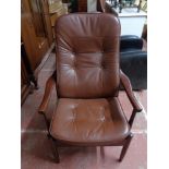 A mid century reclining armchair in brown leather