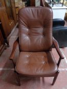 A mid century reclining armchair in brown leather