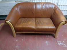 A contemporary two seater beech framed settee